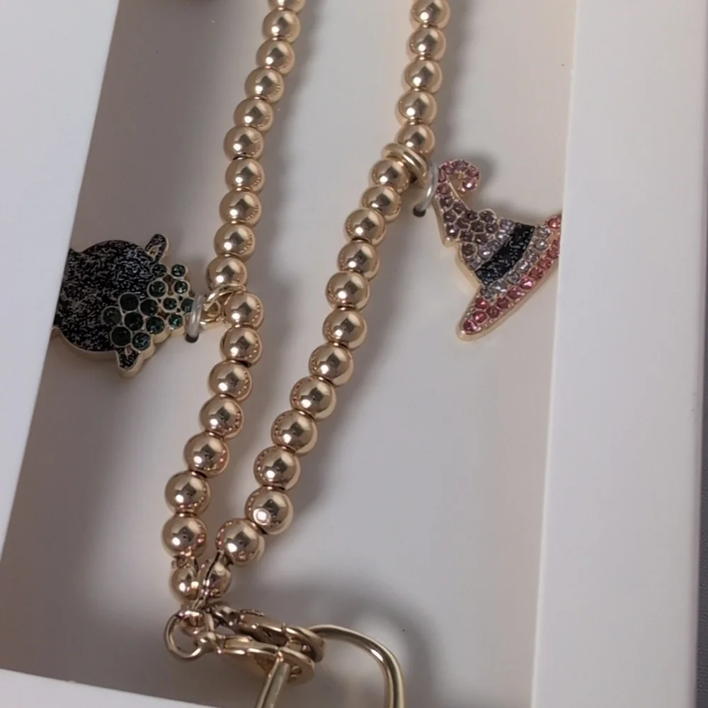 BaubleBar Halloween Themed Gold Tone Phone Charm Wristlet